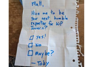 A piece of crumpled up notebook paper with "Matt, Hire me to be your next humble reporter for WP Tavern? Yes? No? Maybe?" written on it.